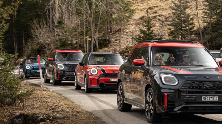 MINIs driving on mountain road MINIs driving on mountain road